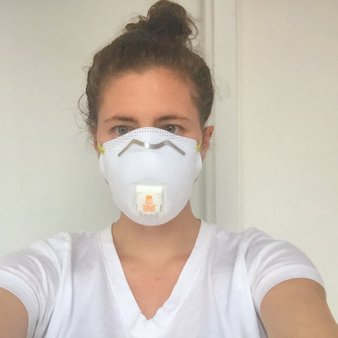 melanie disalvo wearing a dust mask to protect from stray particles of carbon hydroxide
