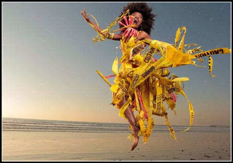 caution warning tape recycled into a dress lady on the beach