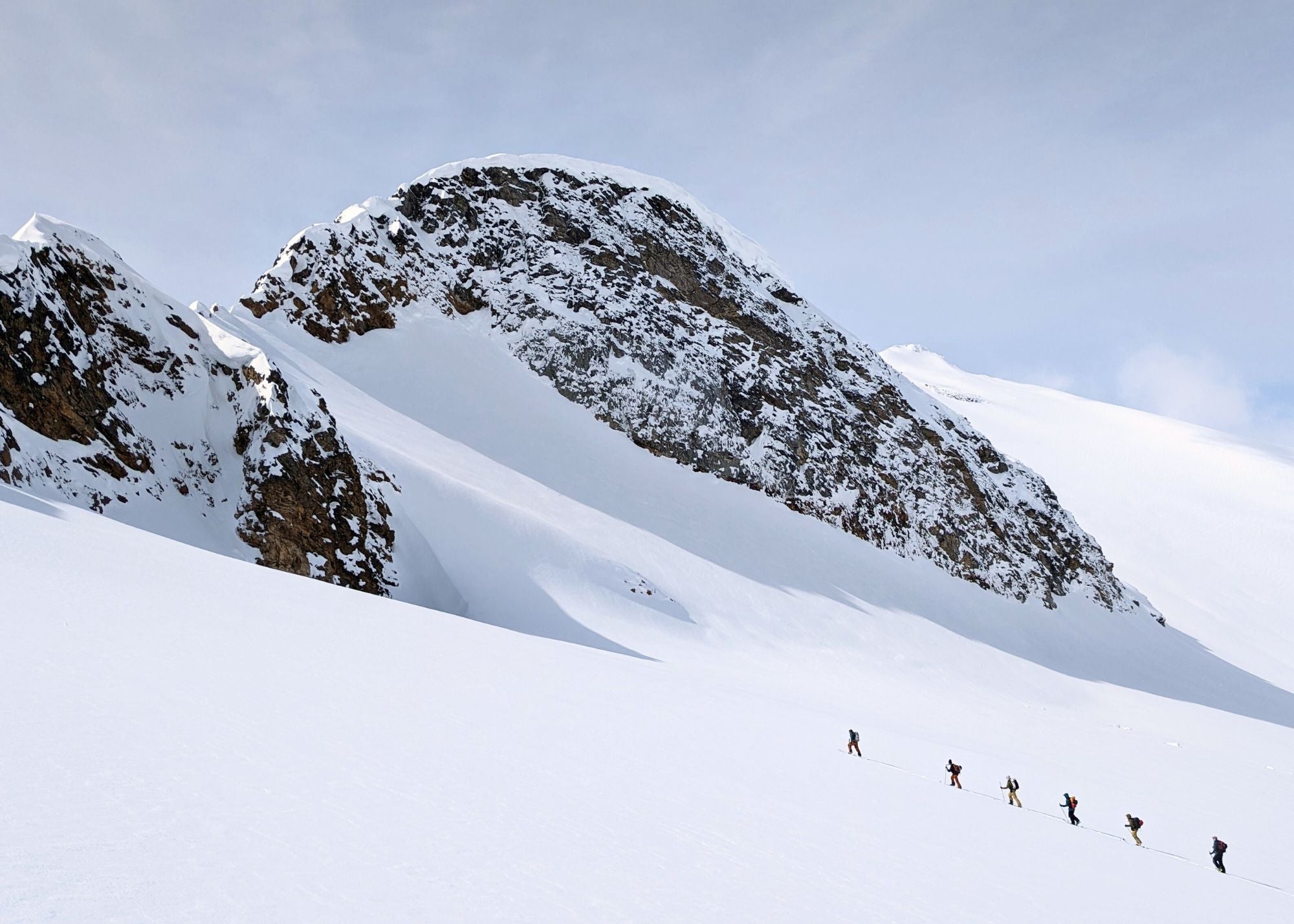 group skinning up a mountain