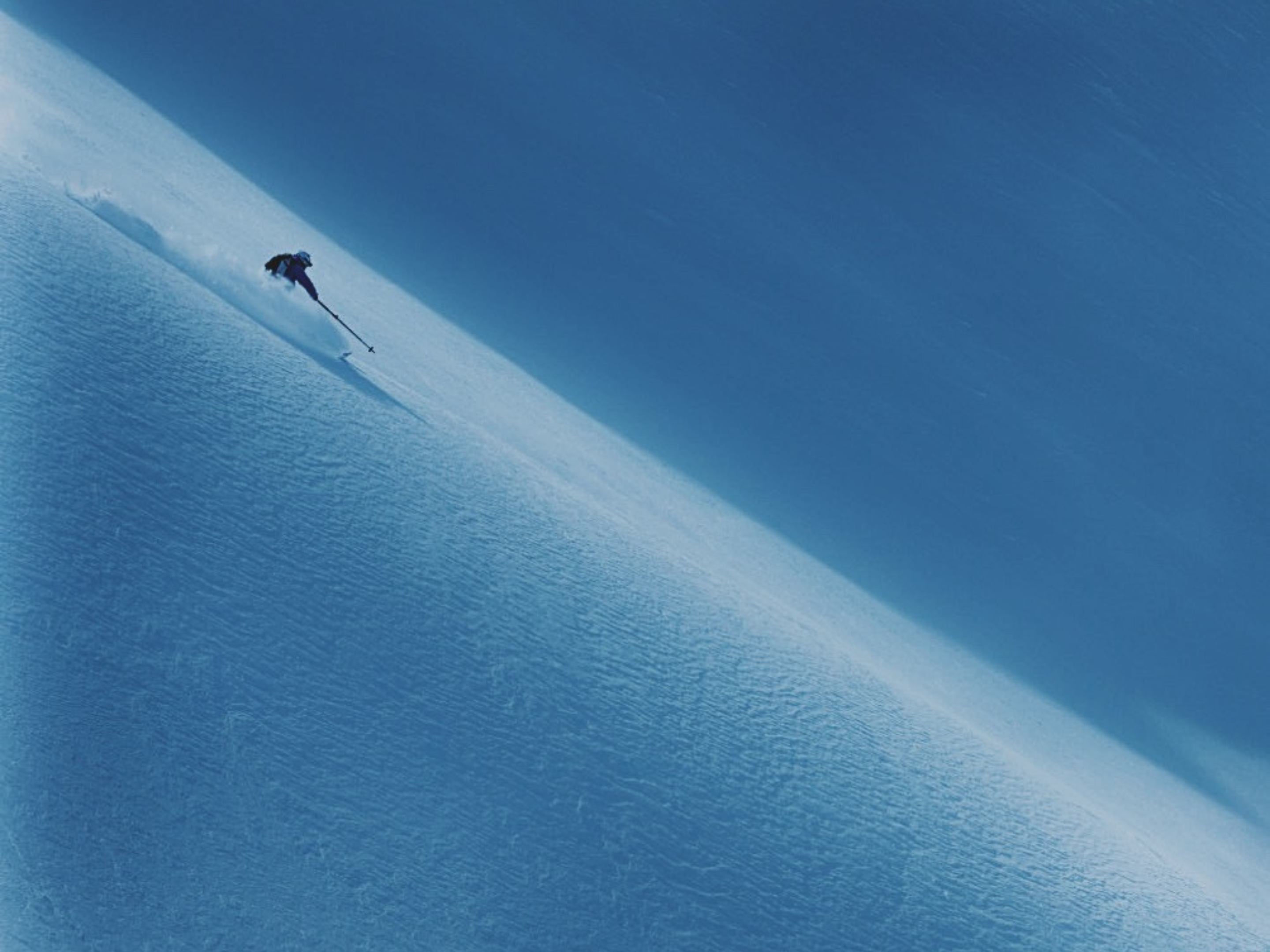 shane skiing a line in the sun of nice powder