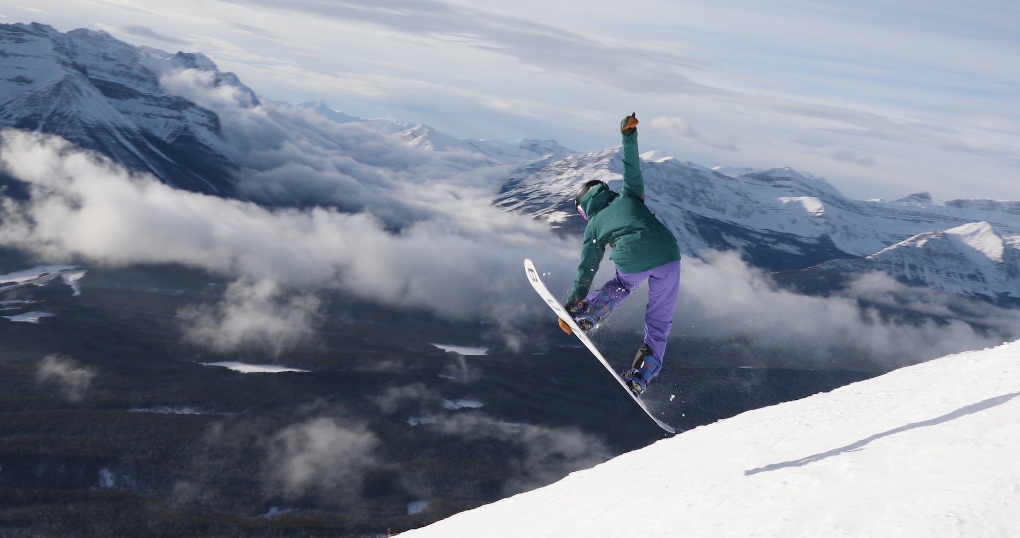 Banff snowboarding,. Audrey getting air with mountains in the background