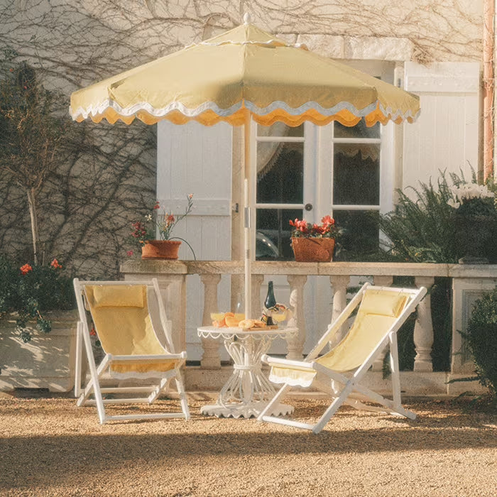 Yellow Sling Chairs and table with an Umbrella