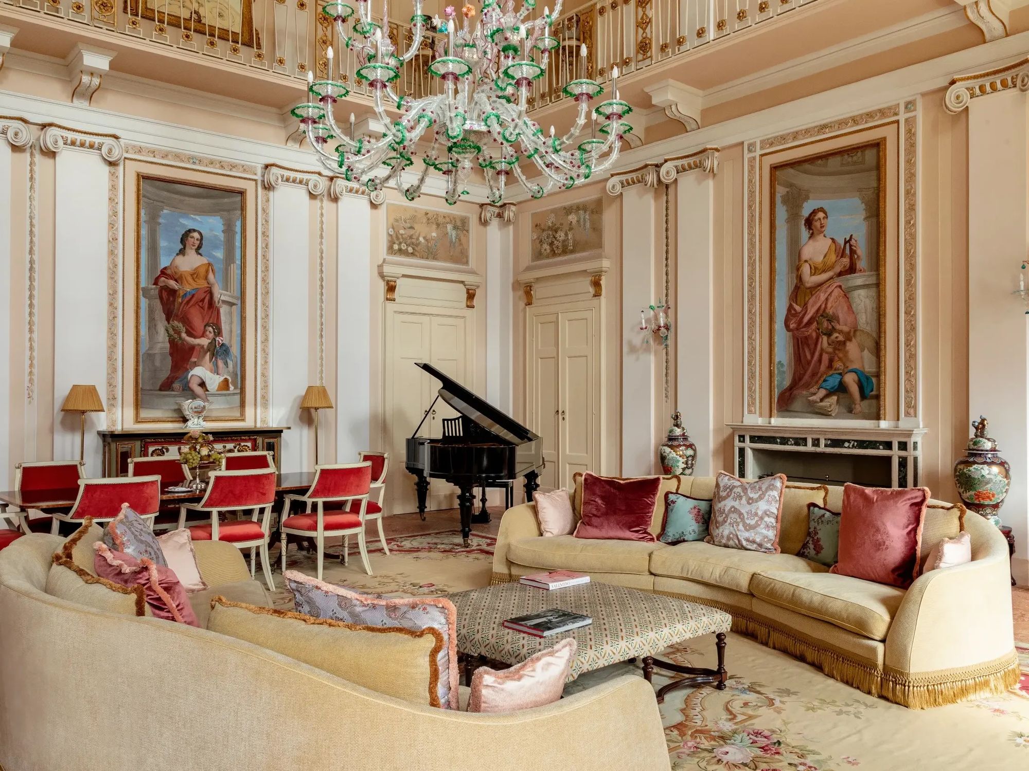 Inside room with a piano and antique couches