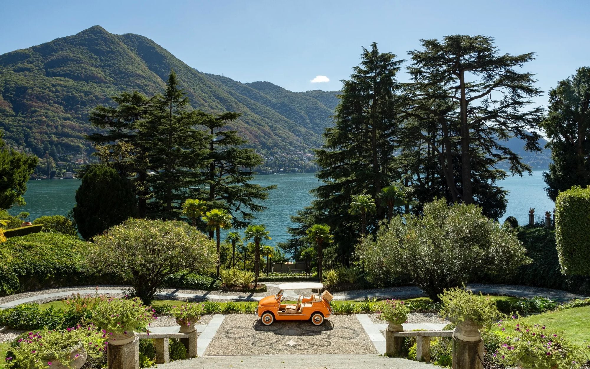 front of hotel entrance with an orange Italian classic car