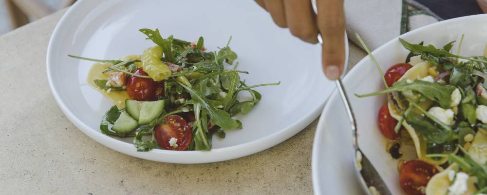 salad being served onto a plate