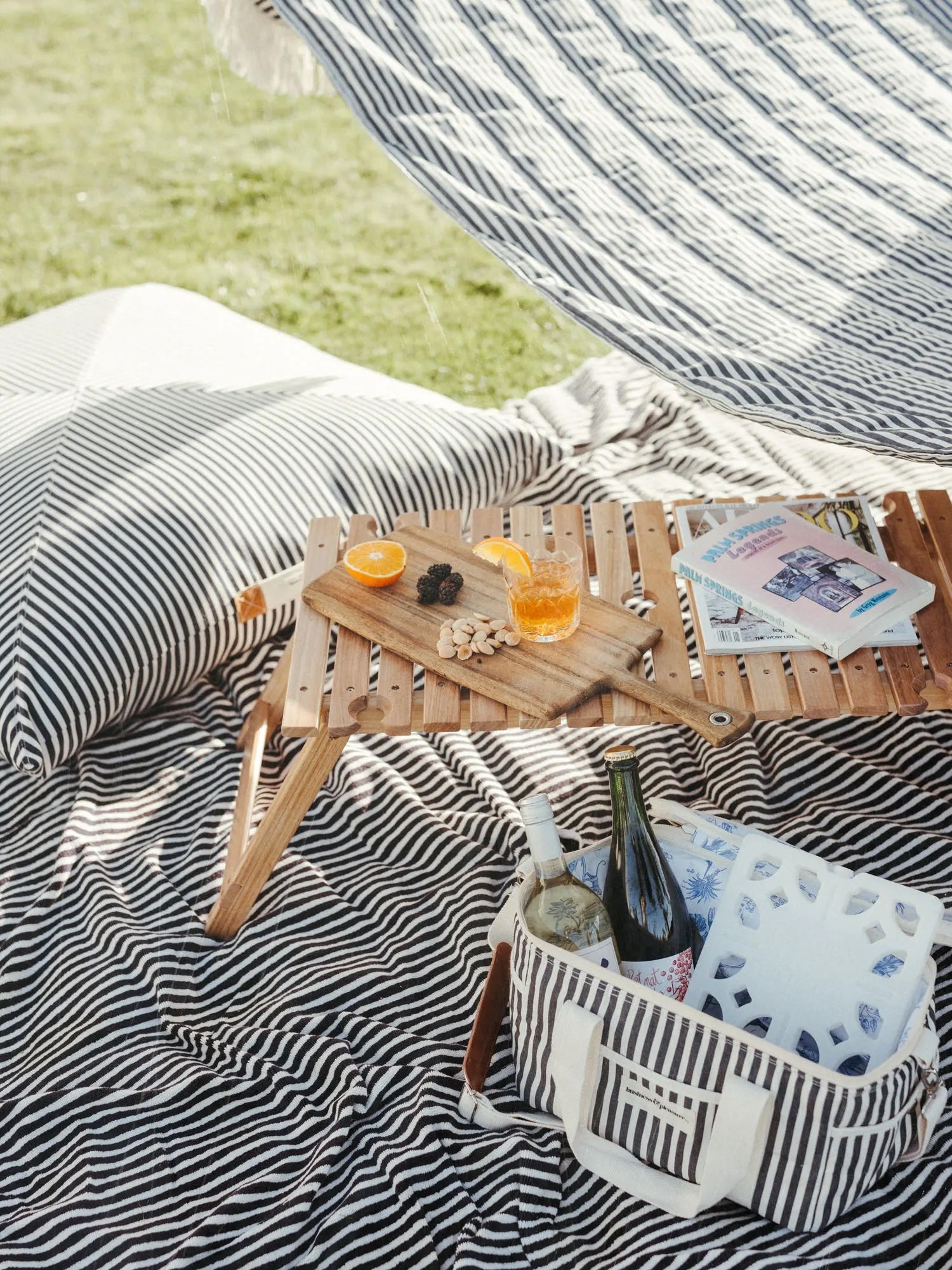 Picnic table with fruit platter and cocktail