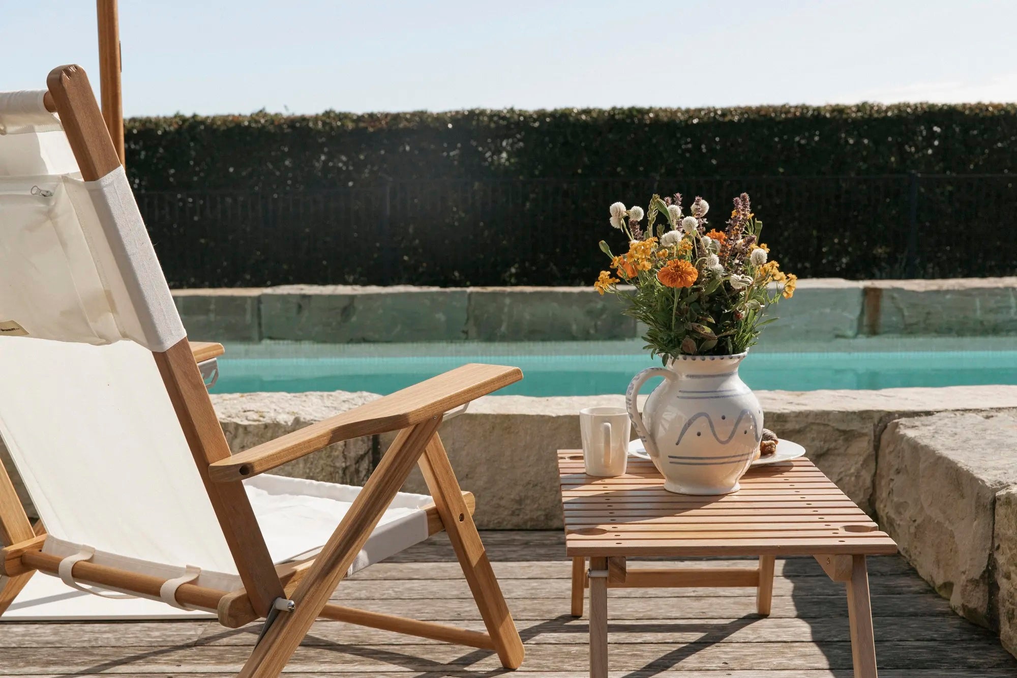 white chair and table poolside