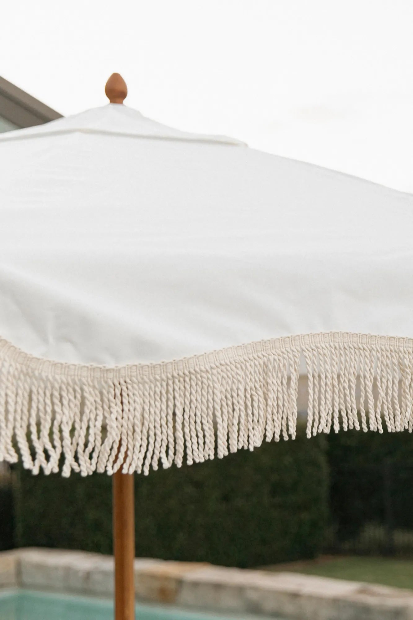 Close up of white market umbrella fringe