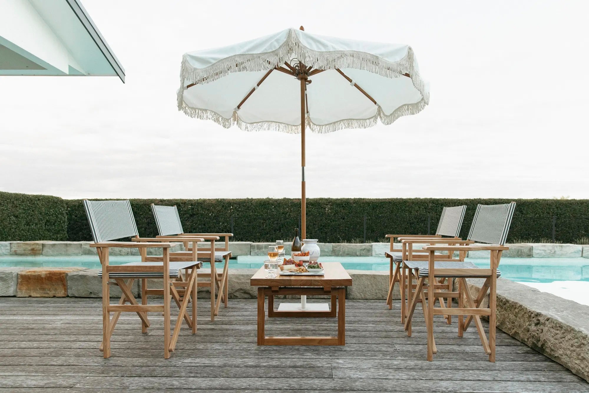 Poolside retreat of umbrella, table and chairs