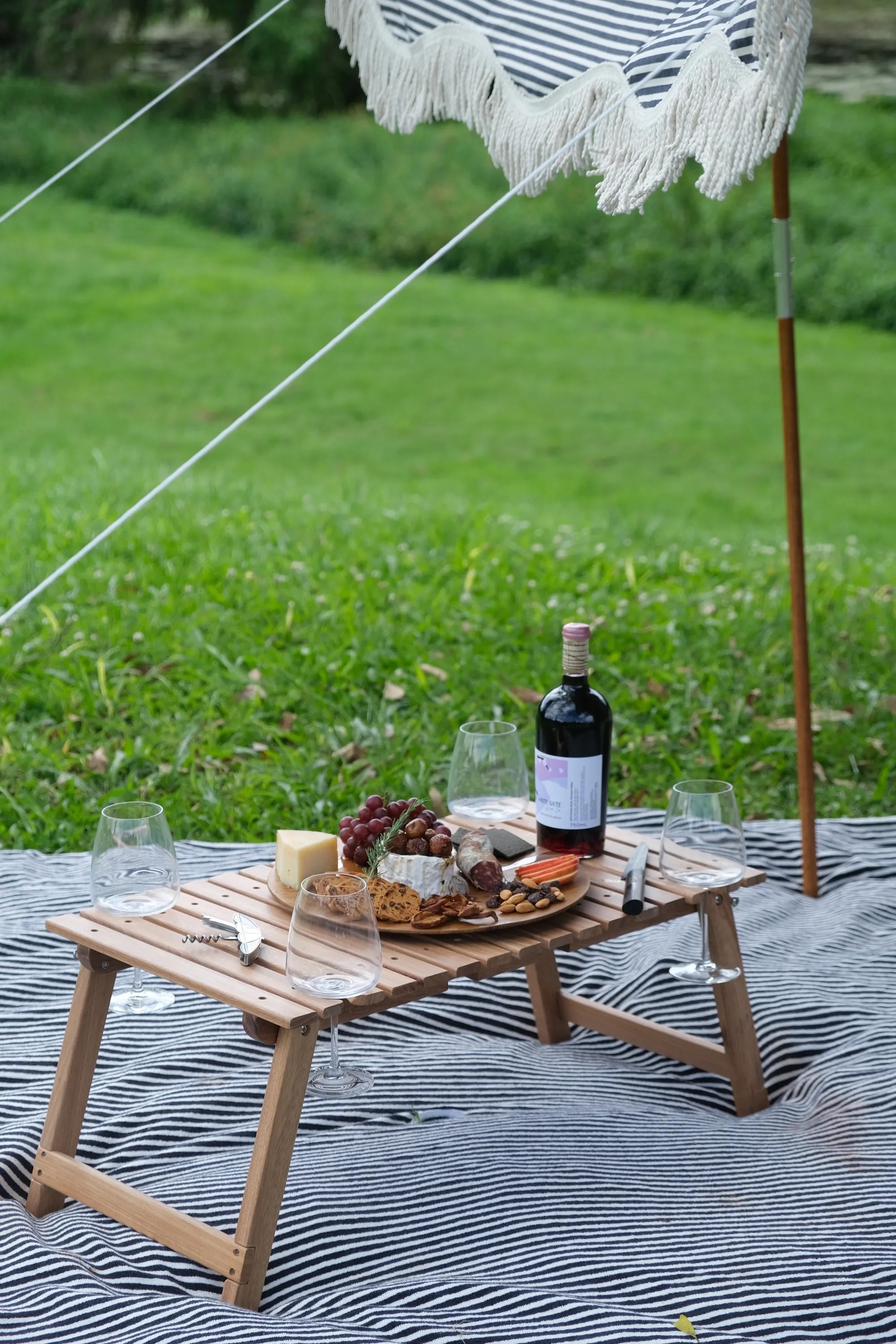 picnic table with food and wine