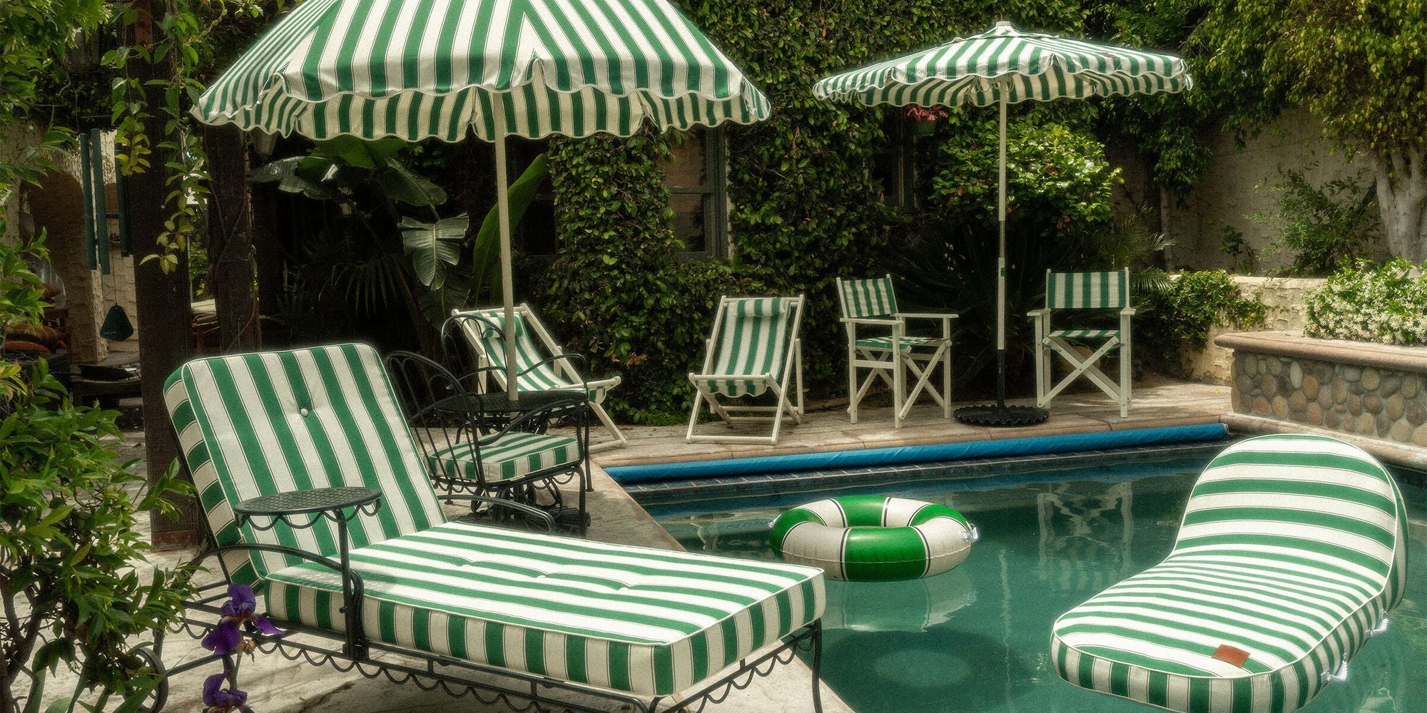 backyard with green striped umbrellas and outdoor furniture