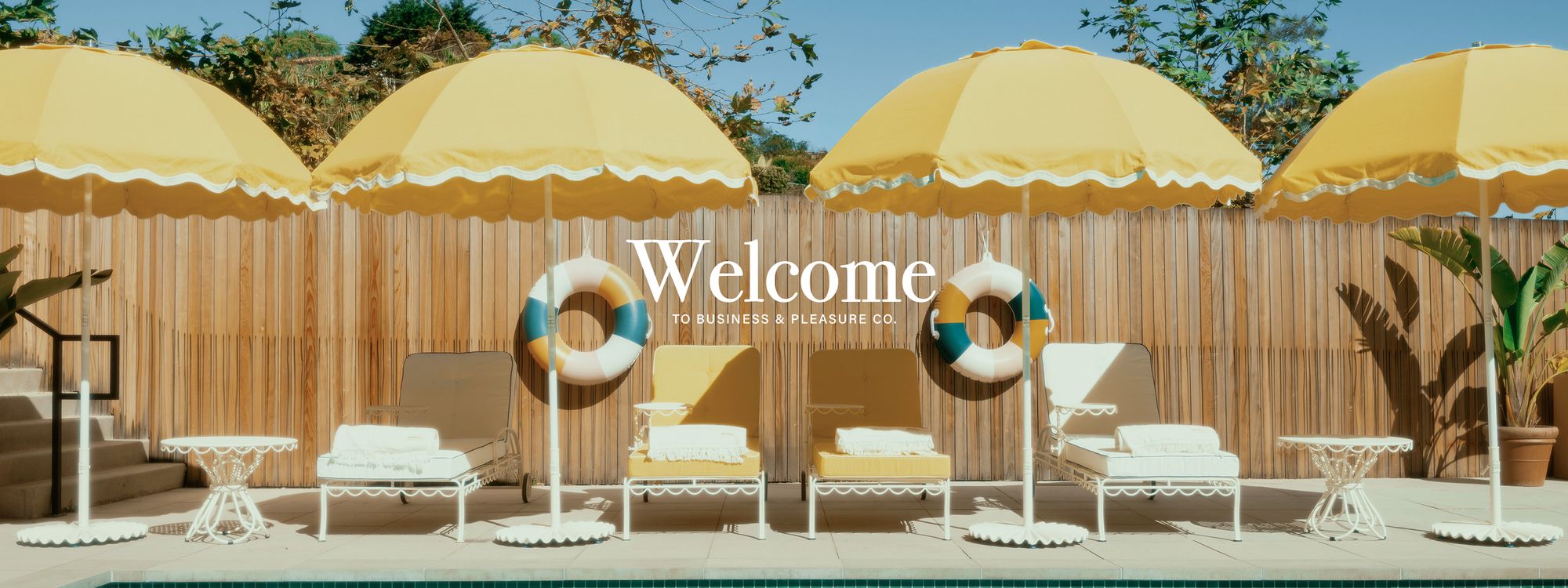 Yellow patio umbrellas on a pool deck with sun lounger chairs