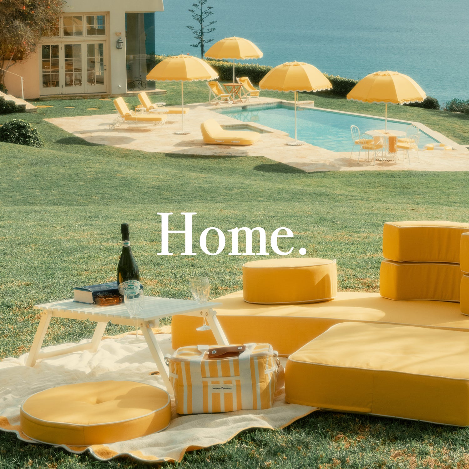 Yellow outdoor cushions on a lawn near a pool