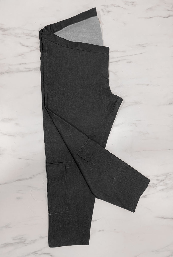 Yuan Ping's customised dark grey denim pants, folded flat in half with one pant leg folded at an angle