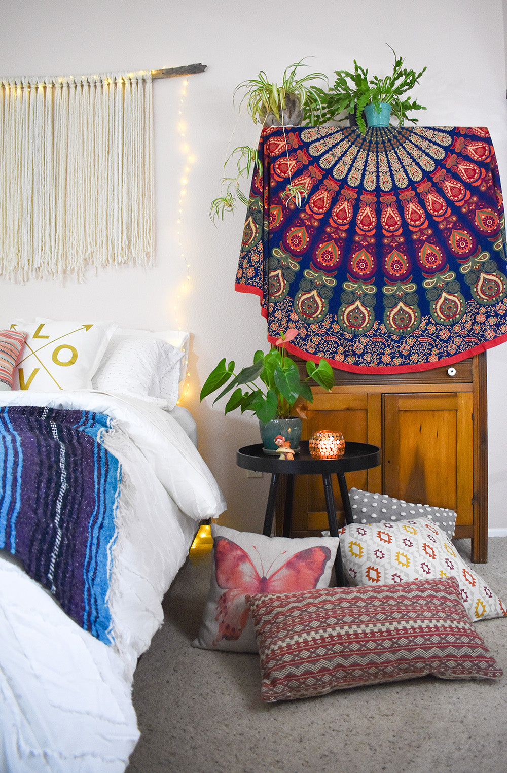 Bedroom decor ideas - round boho tapestries, lots of pillows and plants! via Davis Taylor Trading Co.