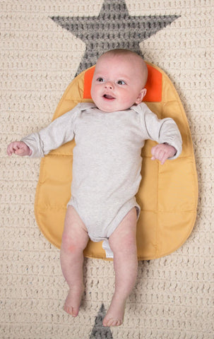 baby on foldable changing mat