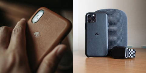 A blue leather iPhone case standing against a speaker next to an Apple watch