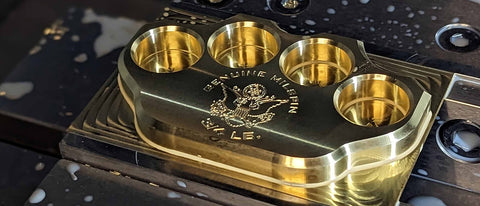 Premium brass knuckle paperweights machined in the USA and engraved to perfection
