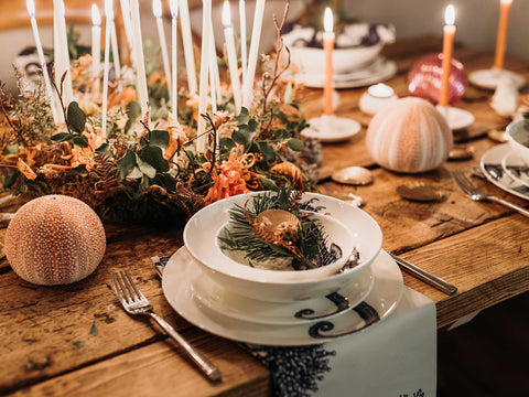 A christmas themed tablescape with lots of lit tapered candles - home decor-Cream Cornwall