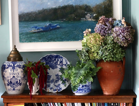 arrangement of objects on the top of a bookcase