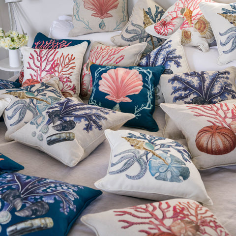 Manderley and Rockpool cushions arranged on a bed