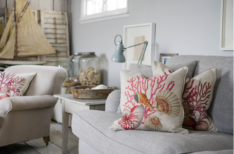 Image of living room with Manderley Shell Seeker cushion on couch-Cream Cornwall