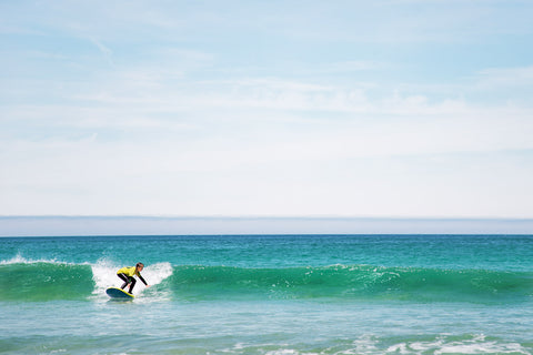 Image of a girl surfing in St Ives at the surf school