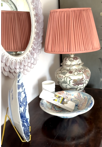 photo showing accessories on top of a mahogany chest of drawers