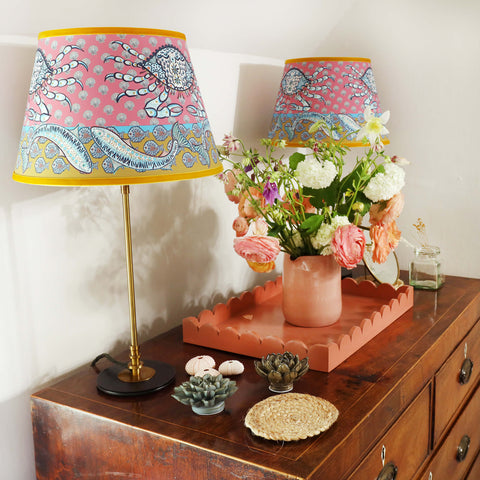 Dresser decorated with two Byron crab lampshades and coral decorations with a large vase of flowers- Cream Cornwall