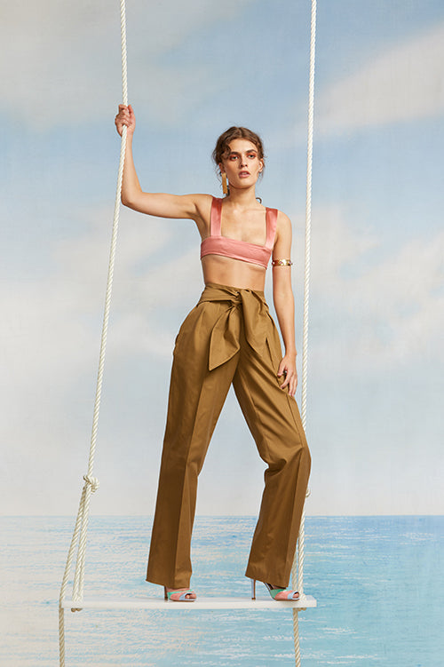 Cynthia Rowley Spring 2018 Look 15 featuring a pink silk bar top and dark khaki pants