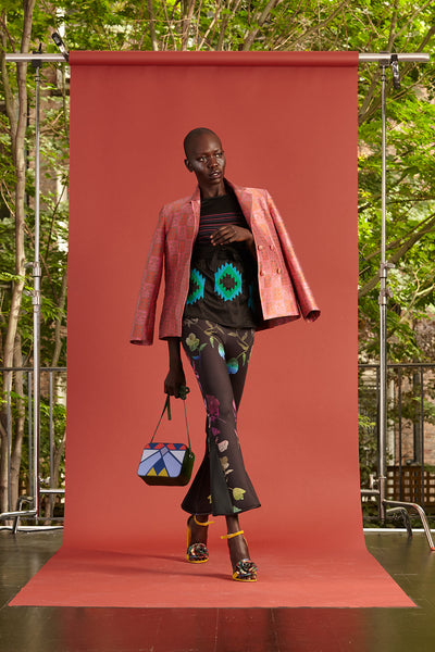 Cynthia Rowley Resort 2017 look 17 featuring a pink blazer, black and blue shirt, and colorful printed flares