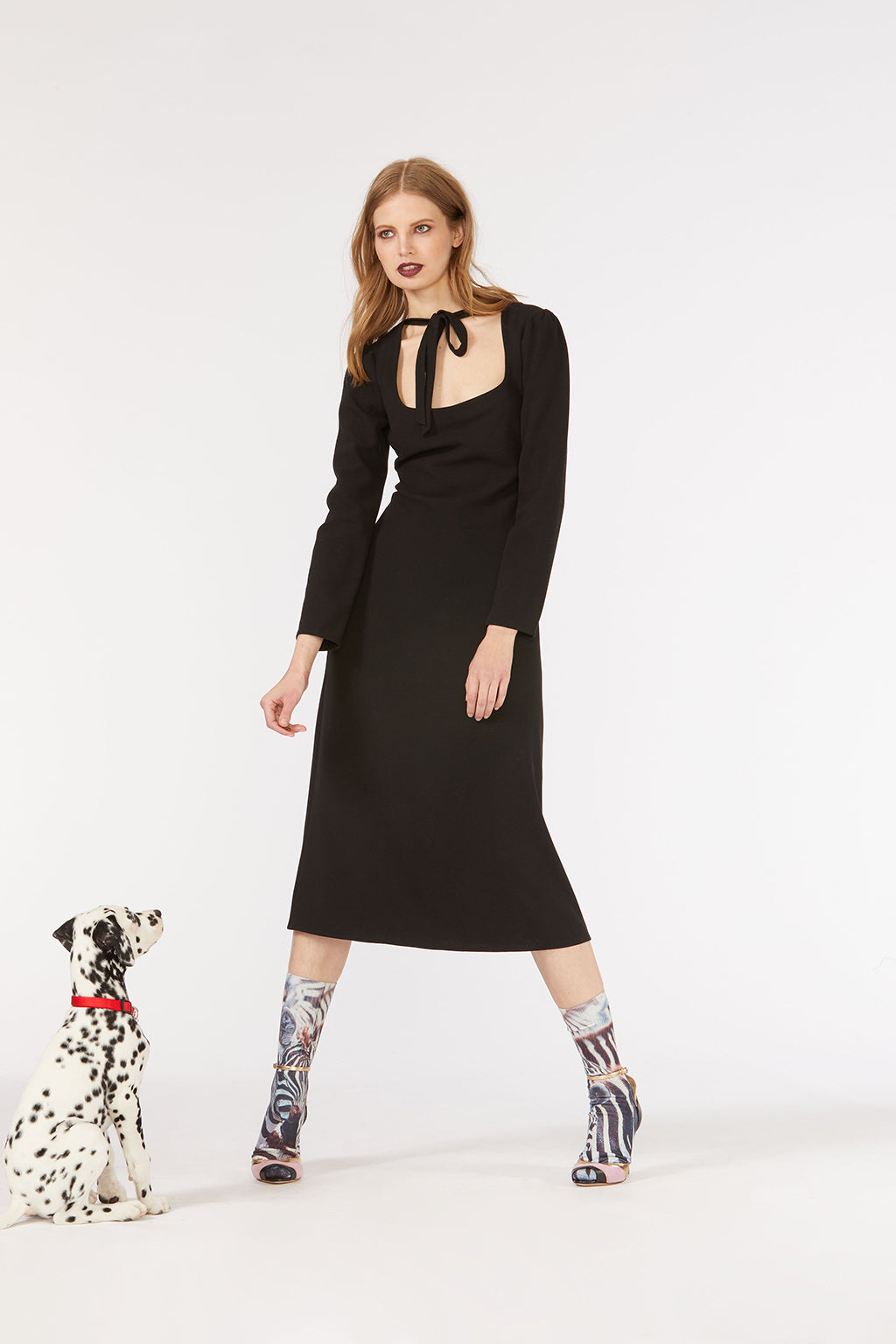 Cynthia Rowley Fall 2018 look 19 featuring a black scoop neck long sleeve midi dress with neck tie detail.