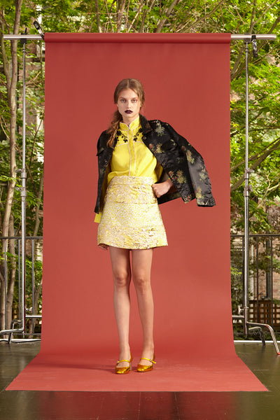 Cynthia Rowley Resort 2017 look 20 featuring a yellow top, light yellow mini skirt, and printed black blazer