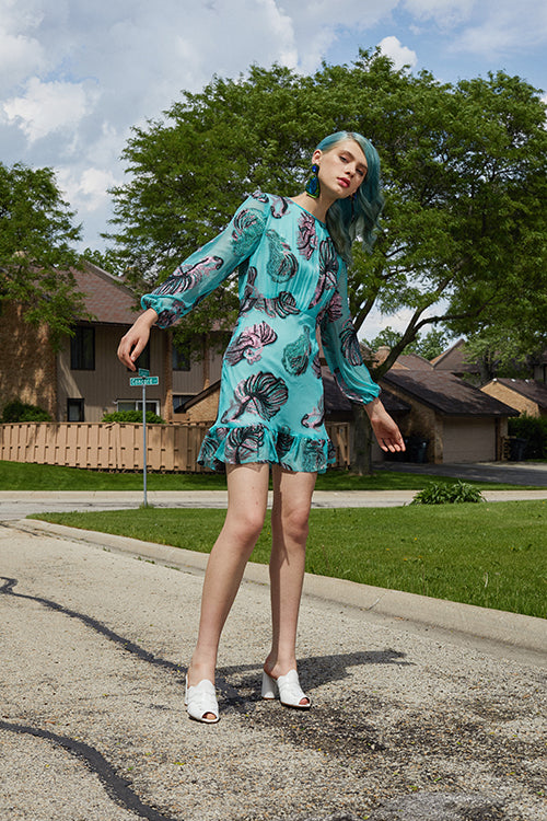 Cynthia Rowley 2019 Resort Collection features a teal mini dress with a pink, black, and teal patterned design. 