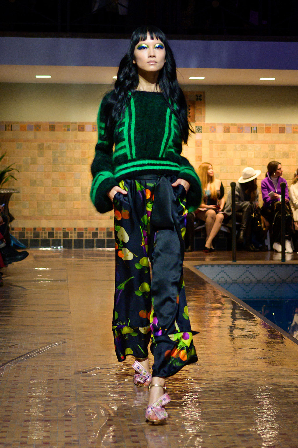 Cynthia Rowley Fall 2019 look 10 featuring a black and green abstract print sweater with long sleeves worn over a fruit printed flare pant