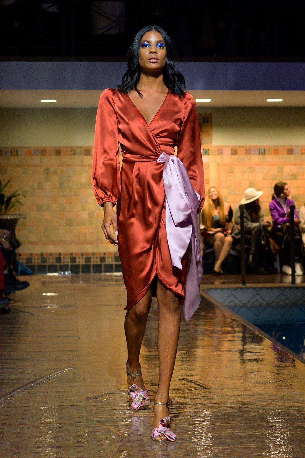 Cynthia Rowley Fall 2019 look 12 featuring an orange silk wrap dress with long sleeves and a large blush bow