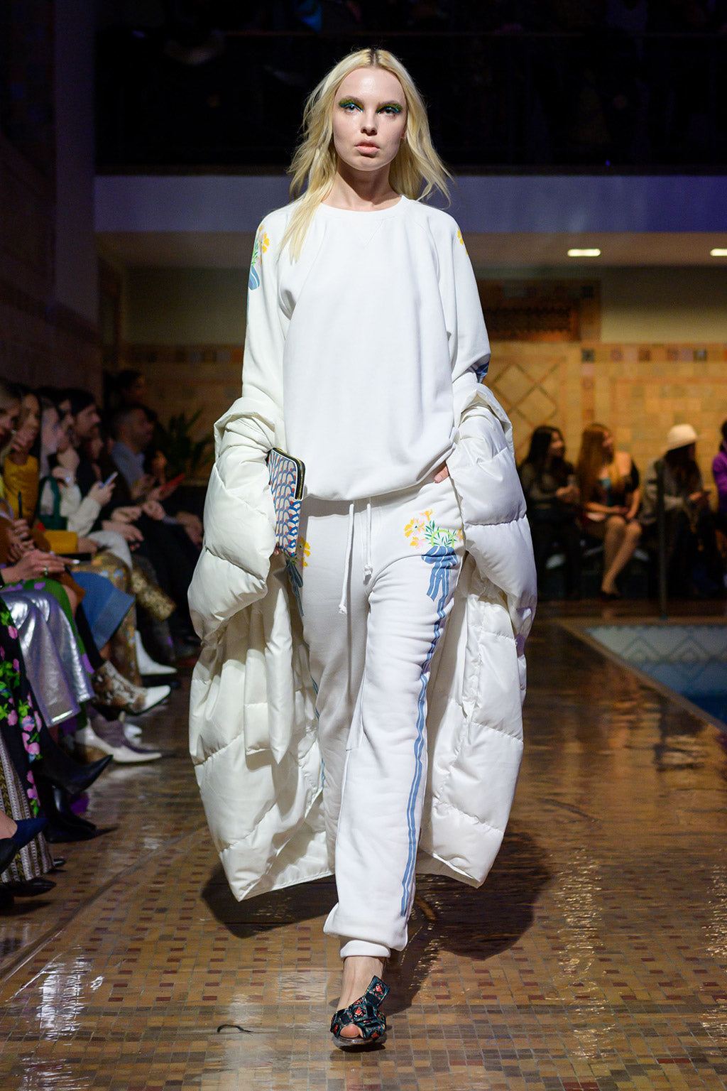 Cynthia Rowley Fall 2019 look 24 featuring a white sweater with floral applications and matching sweatpants with stripes on both sides