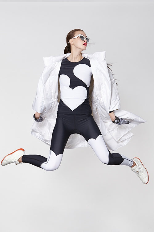 Cynthia Rowley Fall Fitness 2015 look 14 featuring black and white oversize heart printed leggings and shirt, and white oversize quilted down coat