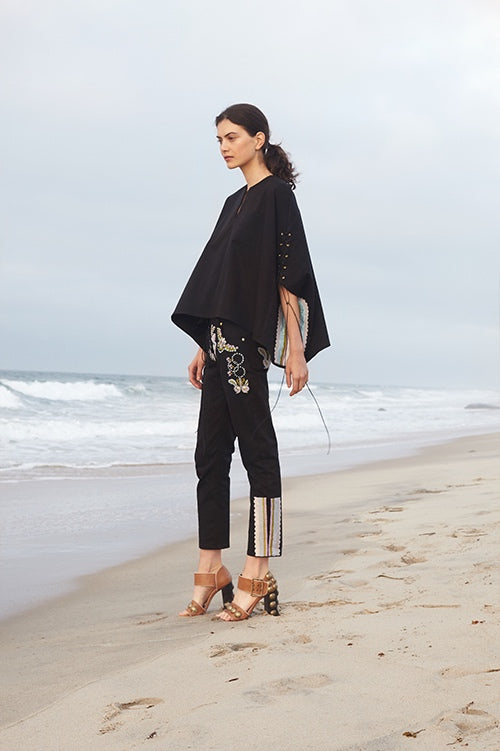 Cynthia Rowley Spring 2016 look 8 featuring black cotton pants and poncho with embroidery