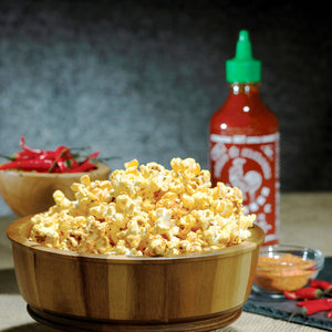 Sriracha popcorn in a wooden bowl