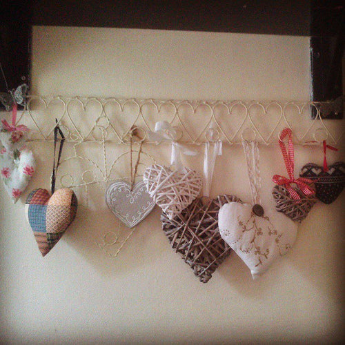 9439780402_2f4a39b7e0 Heart shapes made from different materials hung from a metal heart design hooked rack