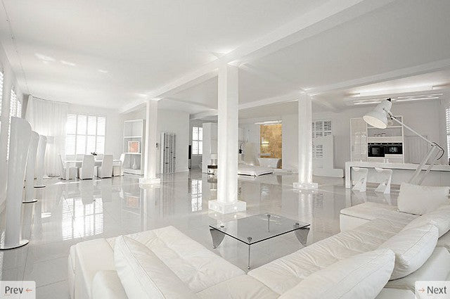 house-with-white-interiors Large open plan white living space with four support columns in white, white sofas, white dining table and white bedroom