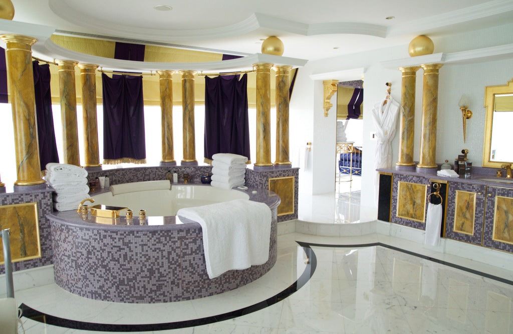 DSC_0787 White bathoom with light purple tiles, dark purple privacy curtains and nine gold pillars throughout
