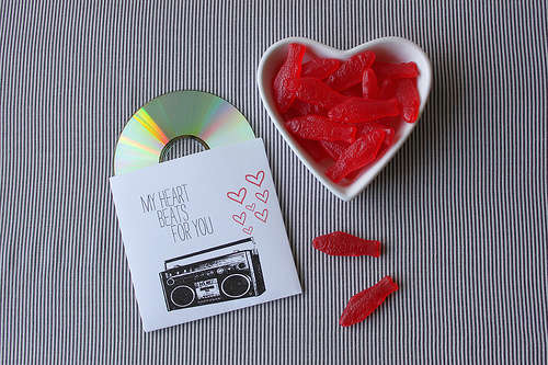 Romantic Mixed CD A ceramic heart bowl containing red sweets and a mixed CD tape