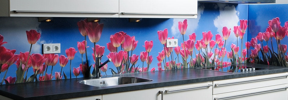 Kitchen counter top with mural splash back of pink flowers and a blue sky background