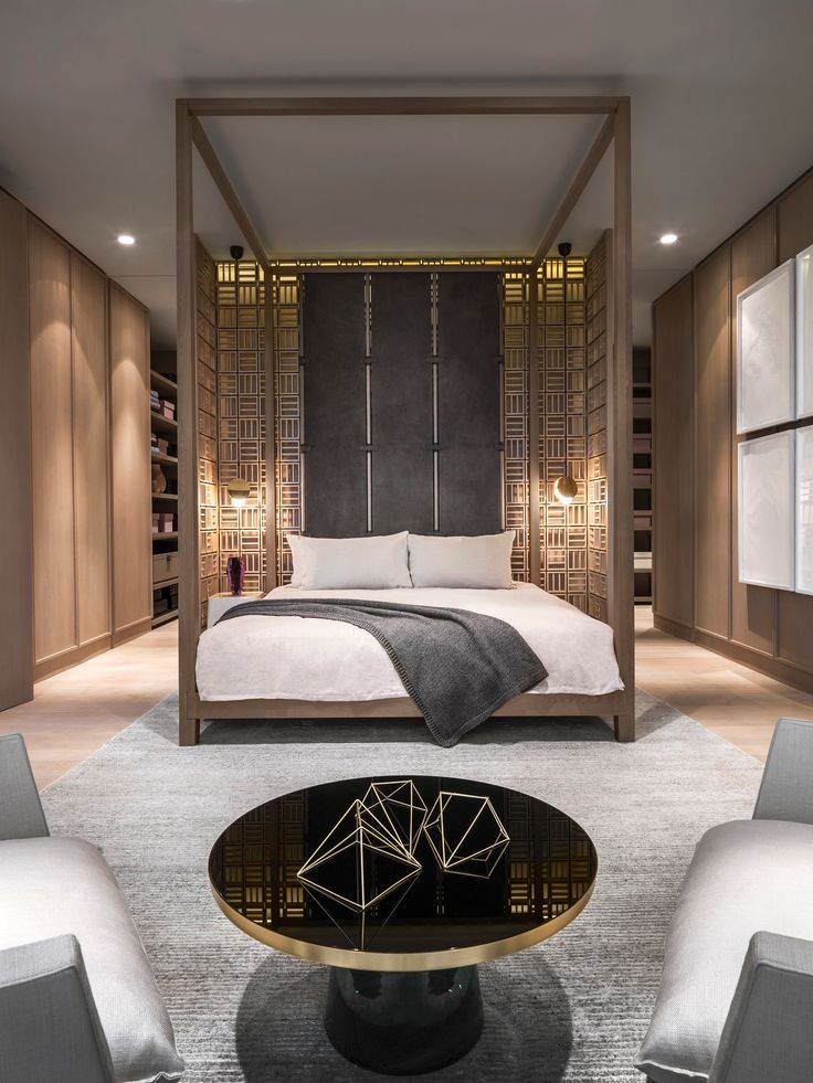 Modern wooden cube four poster bed frame, in a beige, white and grey bedroom