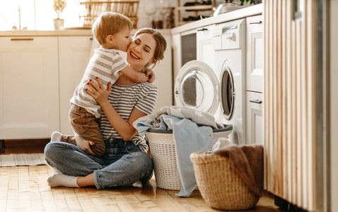 Woman and child unloading washing machine