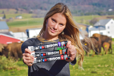 girl holding Buck Wild Bison Bison Fuel meat sticks