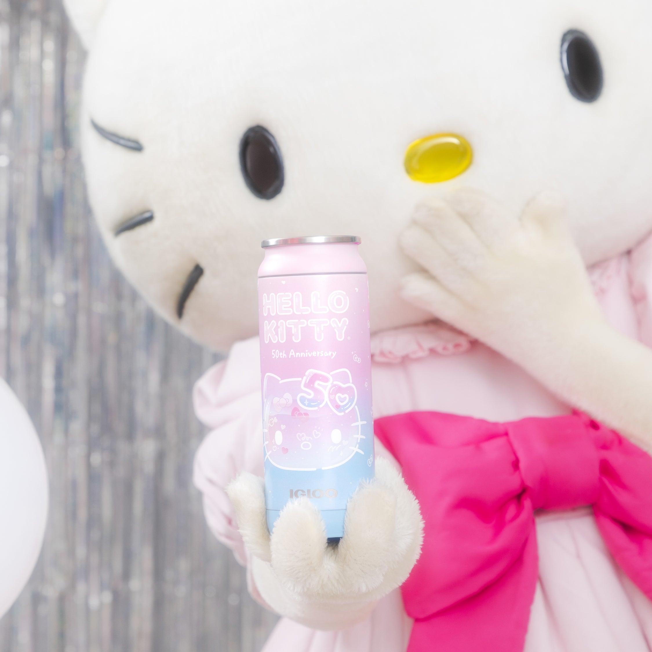 Hello Kitty holding the Hello Kitty® 50th Anniversary 16 Oz Can