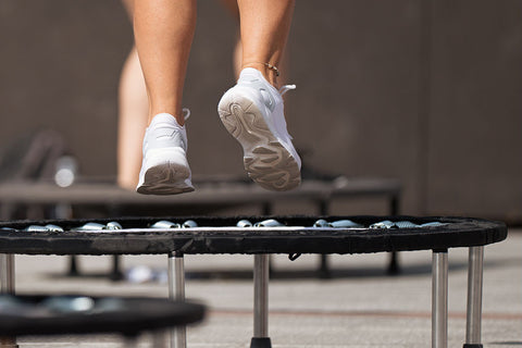 Close-up of woman jumping on mini-trampoline